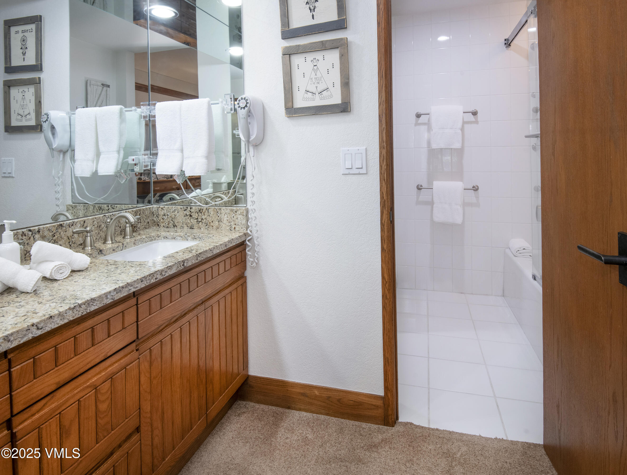 120 Offerson Road, Unit 6140 Beaver Creek, CO 81620 - Photo 15 of 38 a bathroom with a granite countertop sink and a mirror