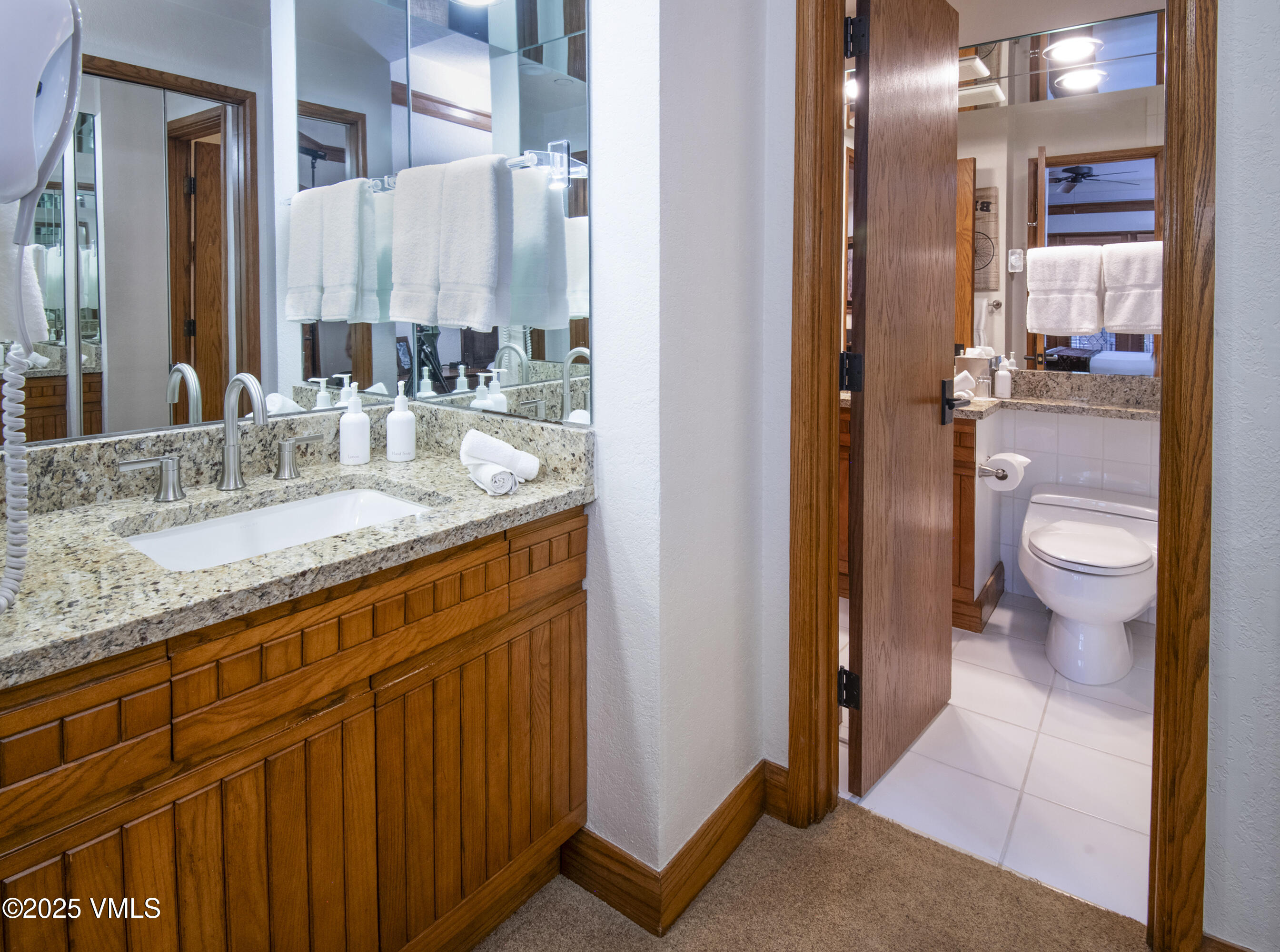 120 Offerson Road, Unit 6140 Beaver Creek, CO 81620 - Photo 19 of 38 a bathroom with a granite countertop sink a toilet a mirror and shower