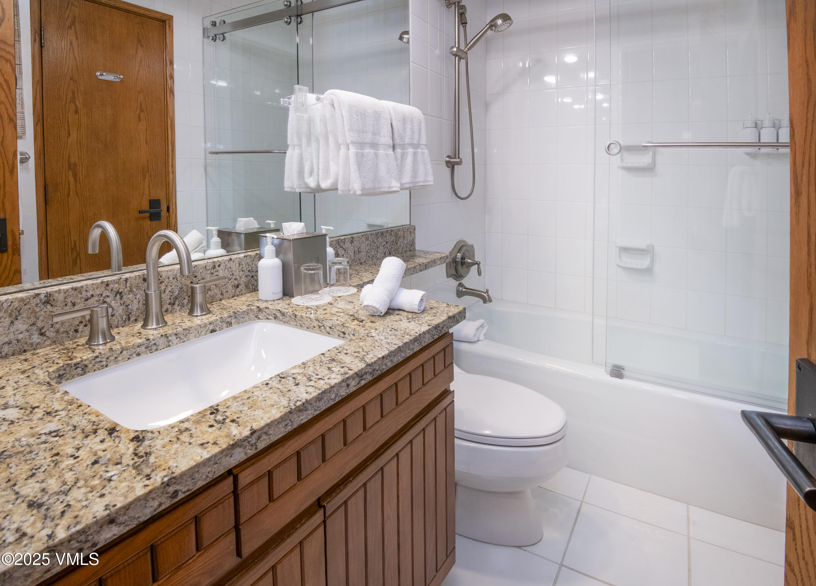 120 Offerson Road, Unit 6140 Beaver Creek, CO 81620 - Photo 20 of 38 a bathroom with a granite countertop sink a toilet and shower