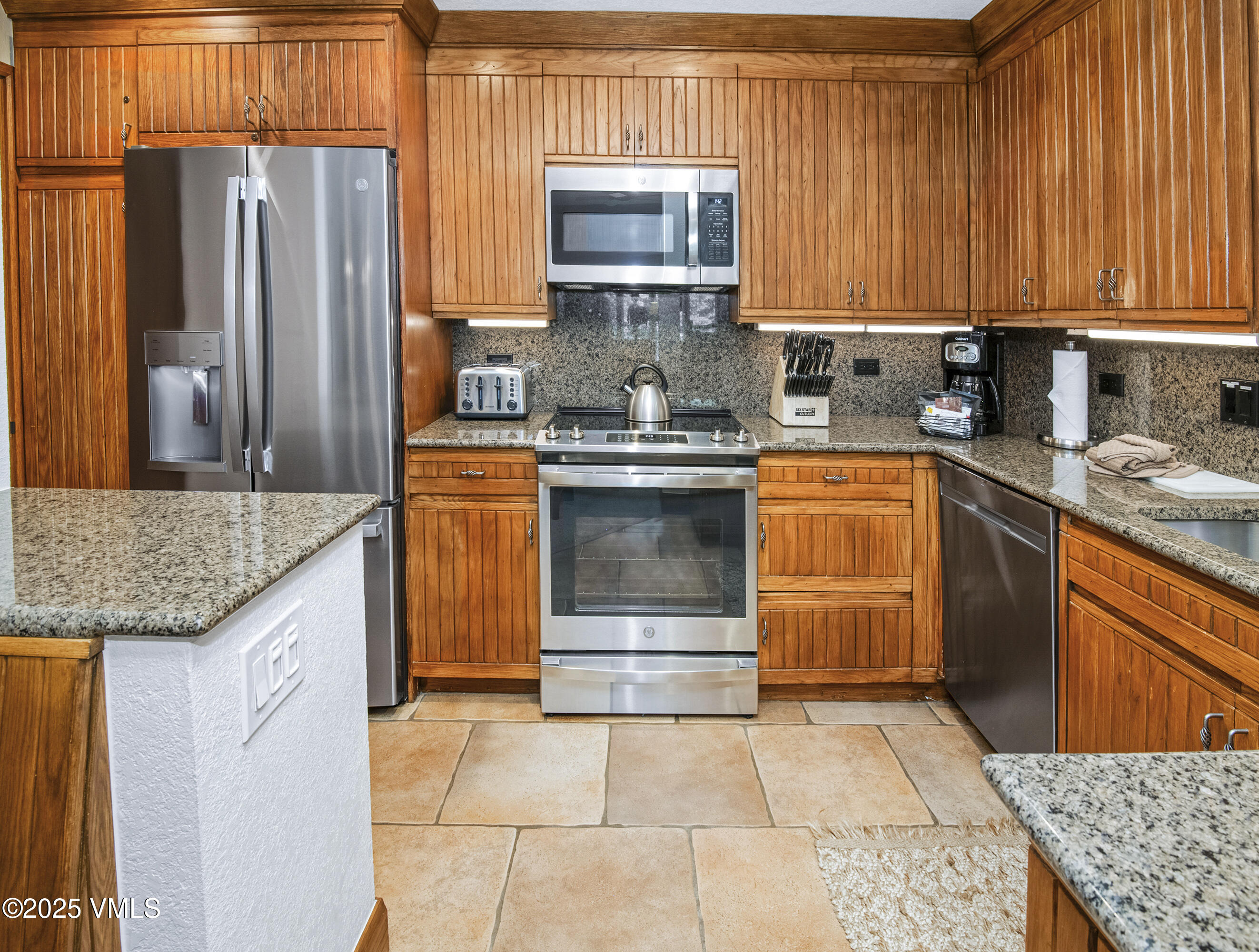 120 Offerson Road, Unit 6140 Beaver Creek, CO 81620 - Photo 3 of 38 a kitchen with stainless steel appliances granite countertop a stove a sink and a microwave