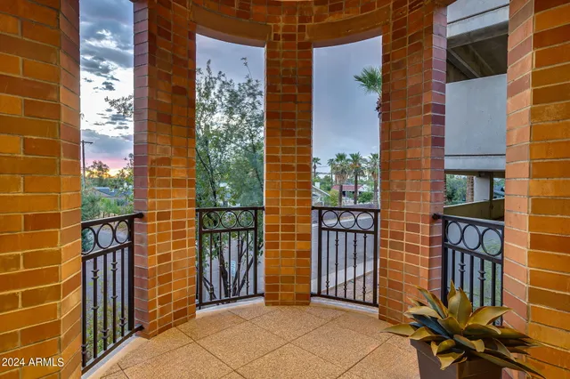 a view of a hallway with wooden floor and stairs