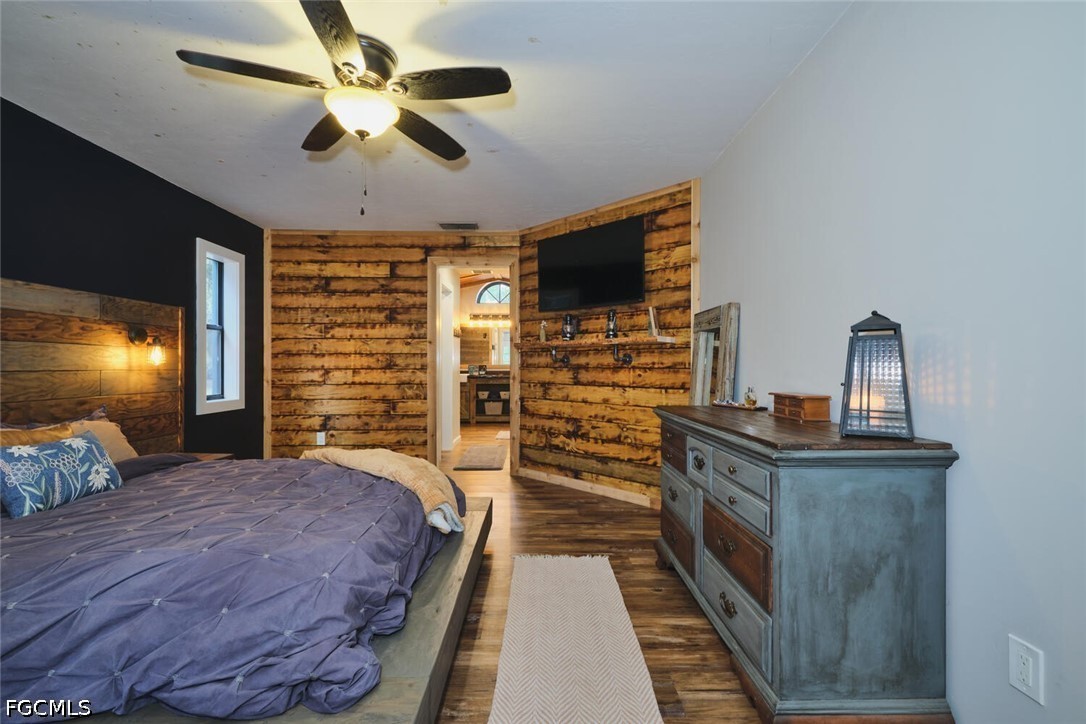 710-740 Evans Road LaBelle, FL 33935 - Photo 13 of 50 a bedroom with a bed and a flat screen tv