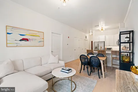 a living room with furniture and kitchen view