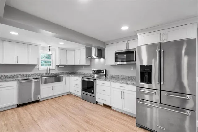 a kitchen with granite countertop a sink and cabinets