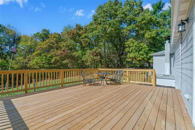 a balcony with wooden floor and fence