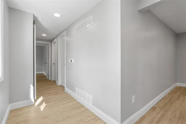 a bedroom with a bed and a potted plant