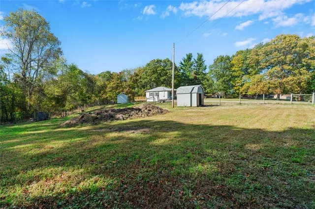 a view of a house with backyard and sitting area