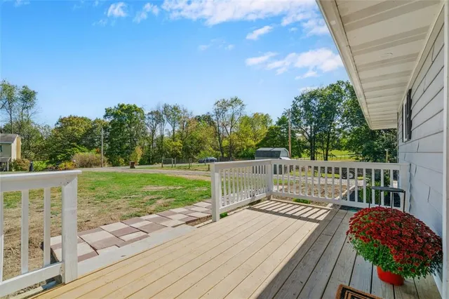 a balcony with wooden floor and fence