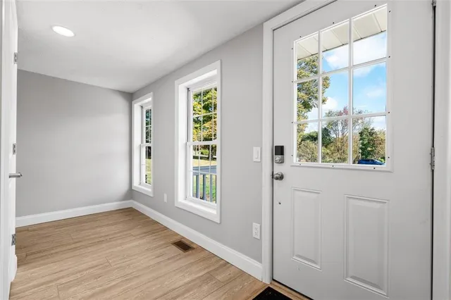 a view of hallway with wooden floor