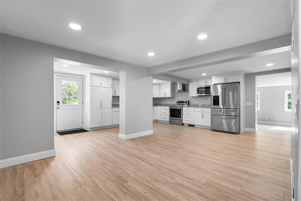 428 Weimer Road Leechburg, PA 15656 - Photo 10 of 42 a view of an empty room and kitchen with wooden floor