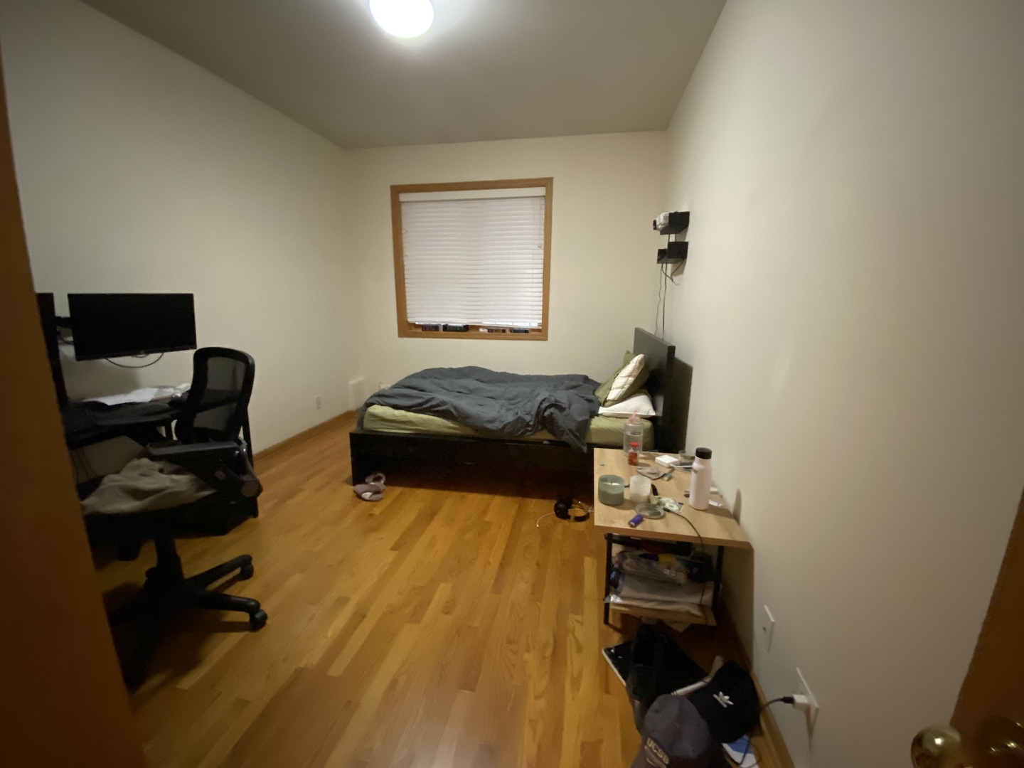 654 West Briar Place, Unit G Chicago, IL 60657 - Photo 14 of 17 a bedroom with a bed and wooden floor