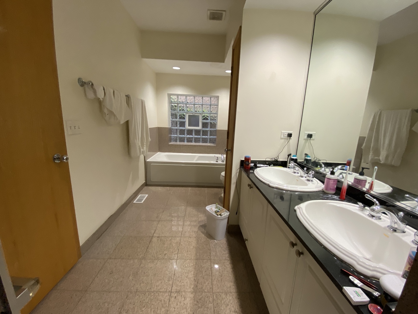 654 West Briar Place, Unit G Chicago, IL 60657 - Photo 8 of 17 a bathroom with a granite countertop sink a mirror and a bathtub