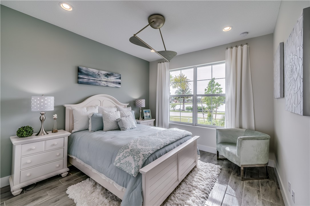 6407 High Pointe Circle Vero Beach, FL 32967 - Photo 13 of 26 a bedroom with a large bed and a window