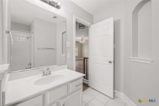 a view of staircase with railing and white walls