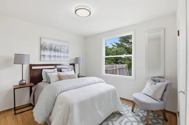 a bedroom with a bed and a window