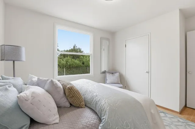 a bedroom with a bed and a window