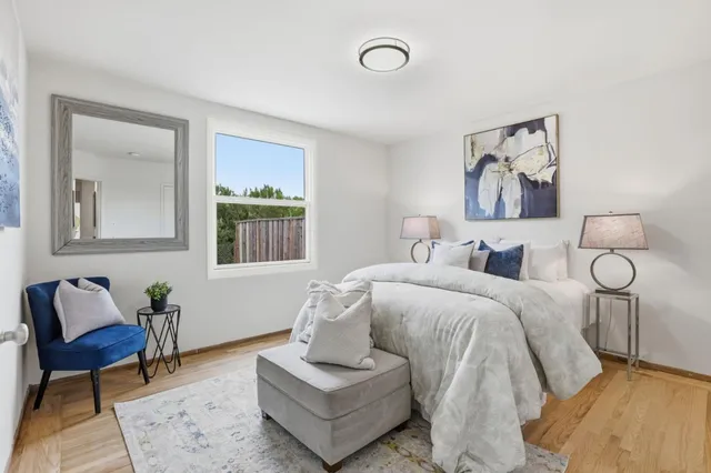 a spacious bedroom with a bed and couch