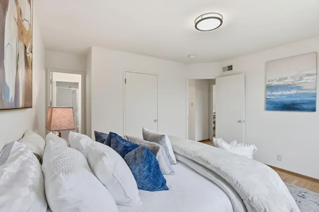 a bedroom with a bed and a lamp