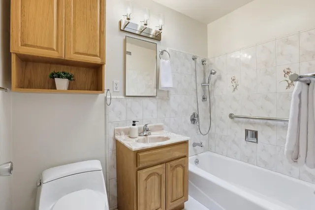 a bathroom with a sink a toilet and bathtub