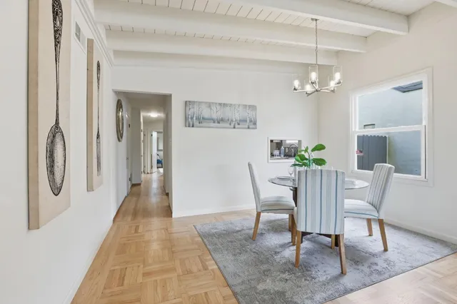 a view of a dining room with furniture and a chandelier