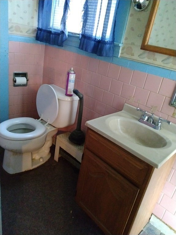 107 Wheelwright Road Barre, MA 01005 - Photo 11 of 15 a bathroom with a toilet sink and mirror