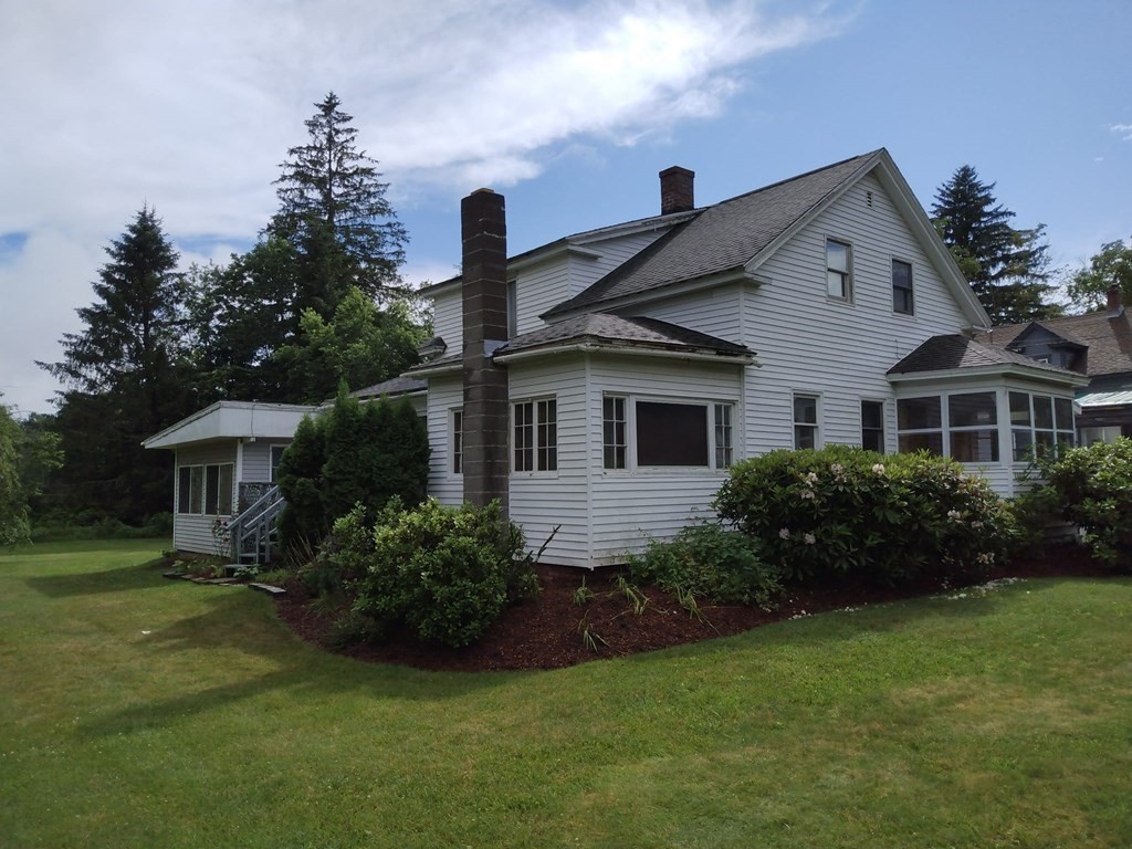 107 Wheelwright Road Barre, MA 01005 - Photo 2 of 15 a front view of a house with a garden and plants