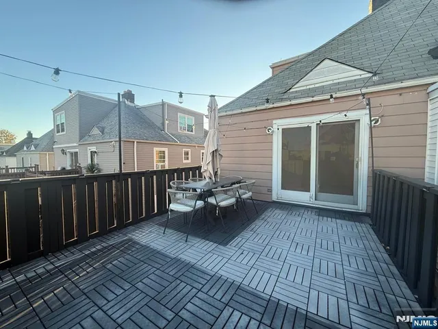 a backyard of a house with barbeque oven and seating space