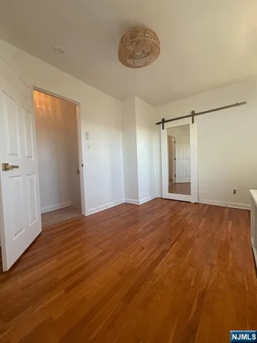 a view of an empty room and wooden floor