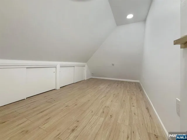 a view of an empty room and wooden floor