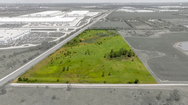 a view of a yard with wooden fence