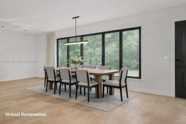 a kitchen with stainless steel appliances granite countertop a kitchen island a stove a sink dishwasher and cabinets with wooden floor