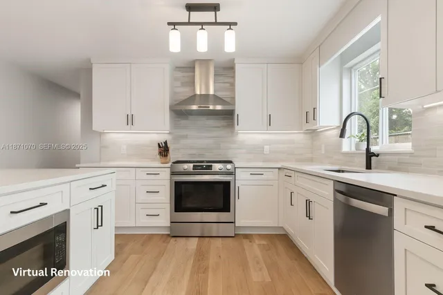a kitchen with cabinets stainless steel appliances and sink
