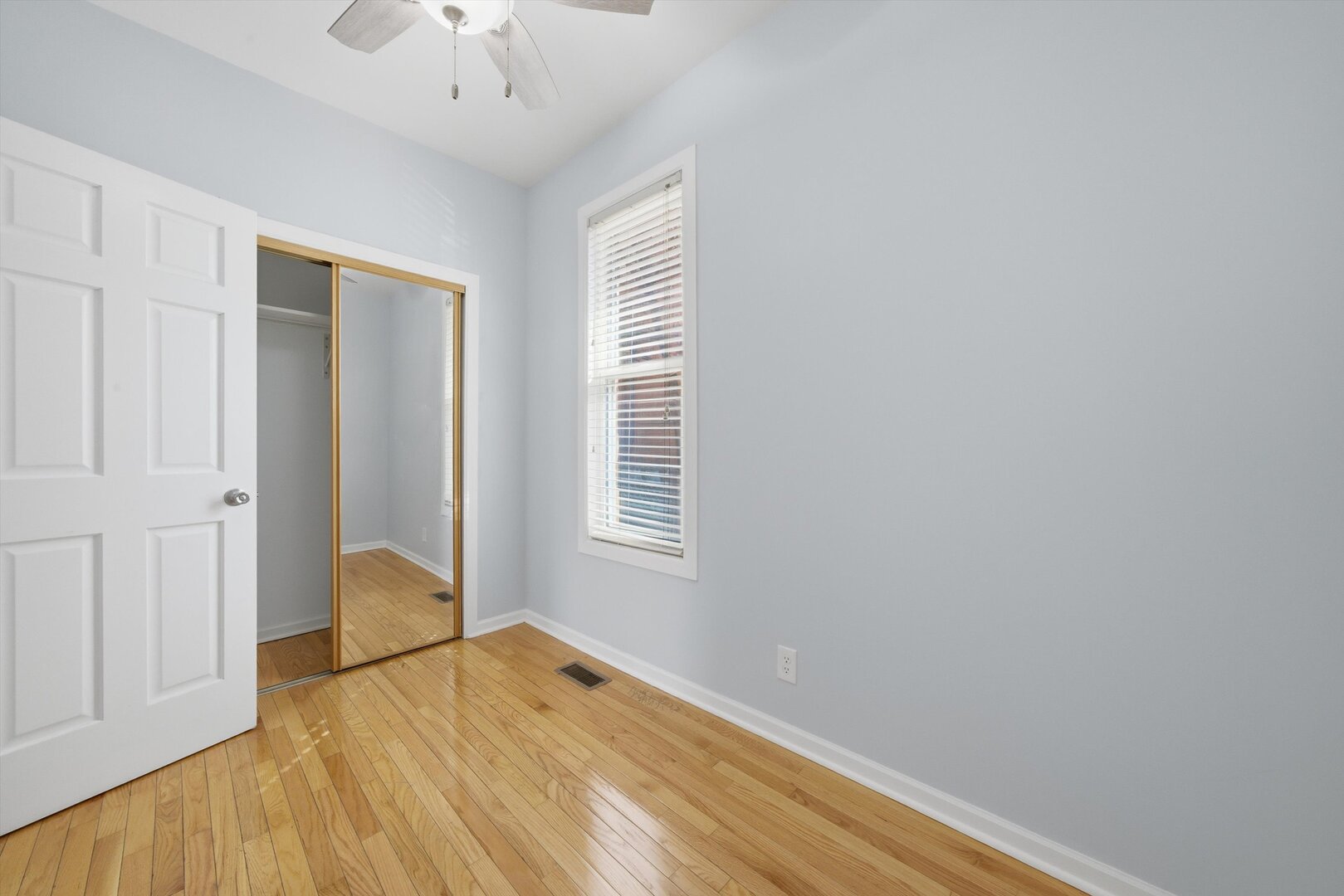 2125 West 18th Place, Unit 5 Chicago, IL 60608 - Photo 18 of 23 a view of an empty room with wooden floor and a window