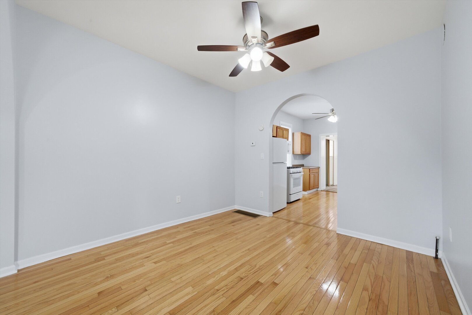 2125 West 18th Place, Unit 5 Chicago, IL 60608 - Photo 3 of 23 wooden floor in an empty room with a window