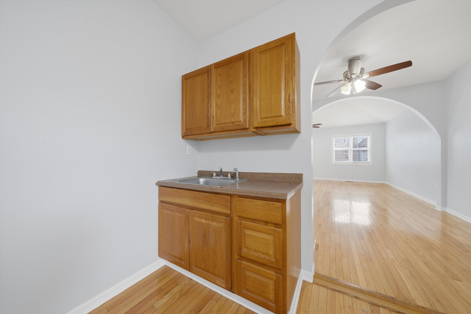 2125 West 18th Place, Unit 5 Chicago, IL 60608 - Photo 9 of 23 a view of a kitchen with wooden floor and cabinet
