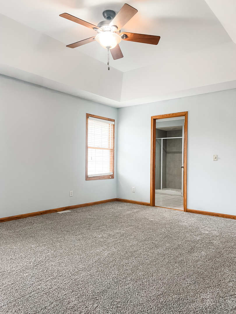 1308 Axcel Lane Sycamore, IL 60178 - Photo 25 of 40 an empty room with chandelier fan and windows