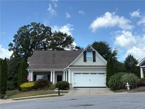 a front view of a house with a garden