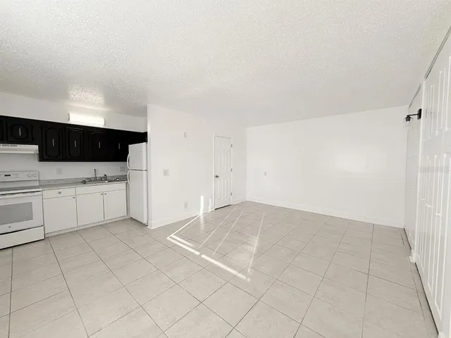 a view of a kitchen with white cabinets
