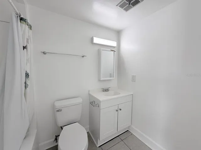 a white toilet sitting next to a bathroom sink