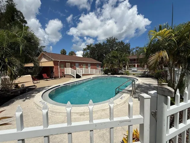 a view of a house with swimming pool and sitting area