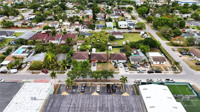 an aerial view of multiple houses with yard