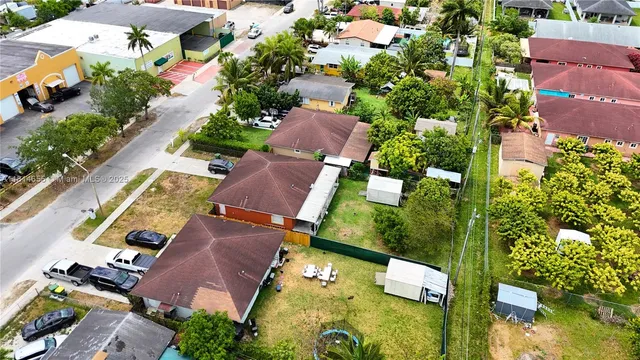 an aerial view of residential houses with outdoor space