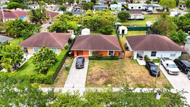 an aerial view of house with yard swimming pool and outdoor seating