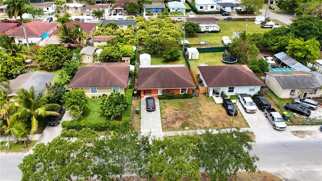 an aerial view of multiple houses with yard