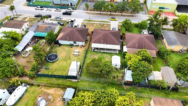 an aerial view of a house with yard swimming pool and outdoor seating