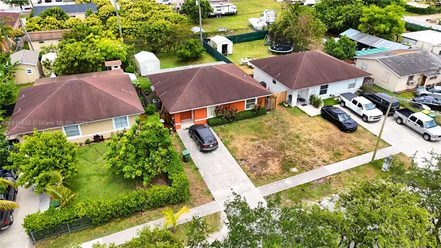 an aerial view of house with garden space and lake view