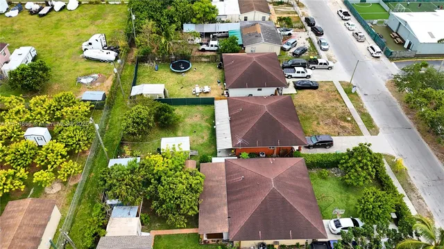 an aerial view of residential houses with outdoor space and street view