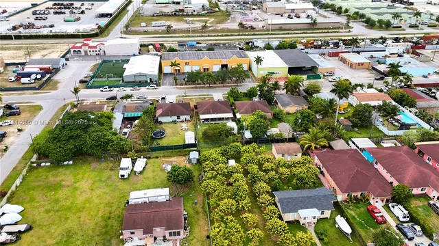 an aerial view of residential houses and car parked