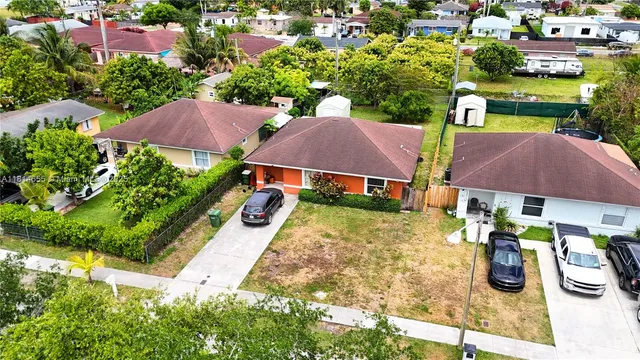 an aerial view of multiple houses with yard