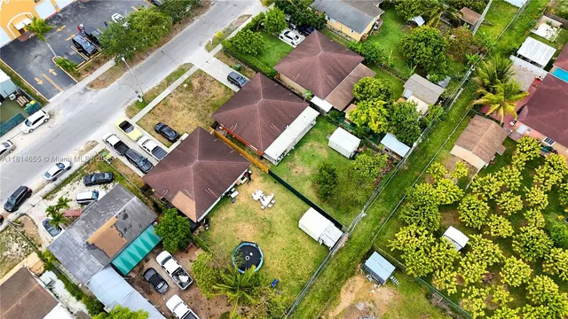 an aerial view of residential house with outdoor space and swimming pool